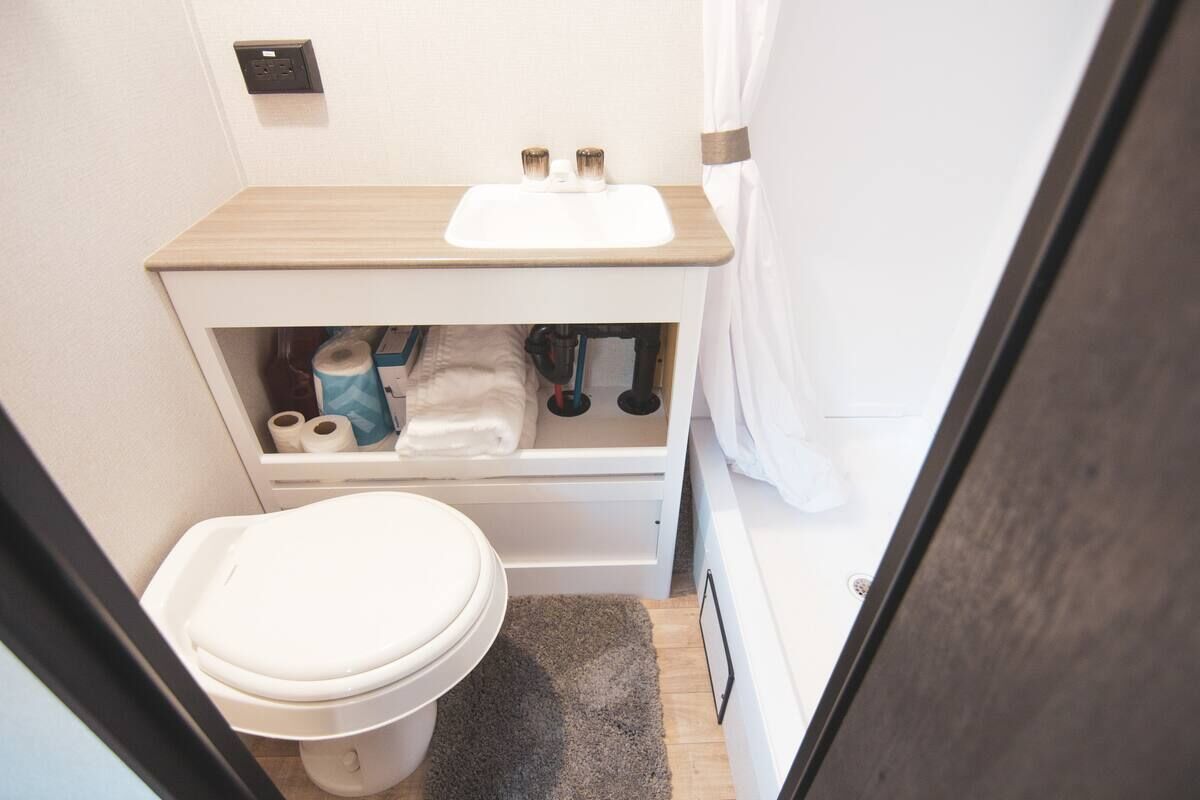 Camper bathroom with a toilet and vanity