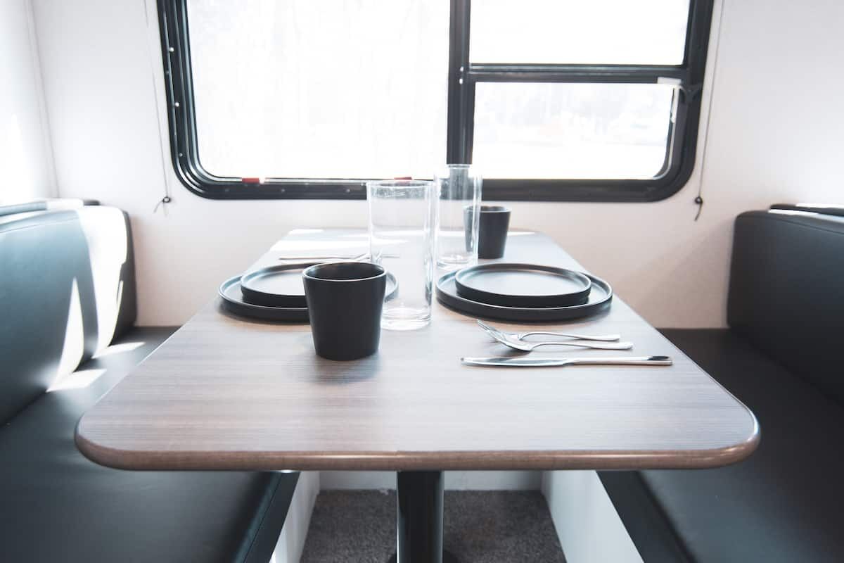 Dinette table set with plates, glasses and a mug