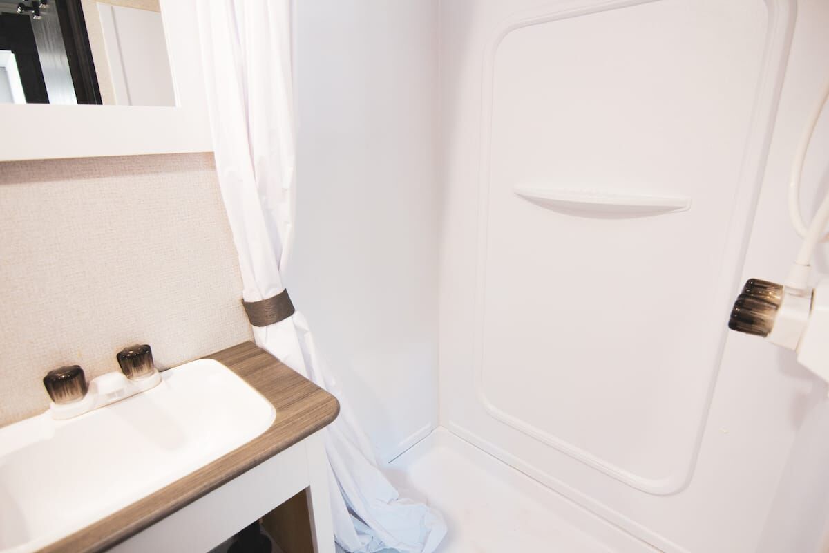 Camper bathroom with a sink and shower