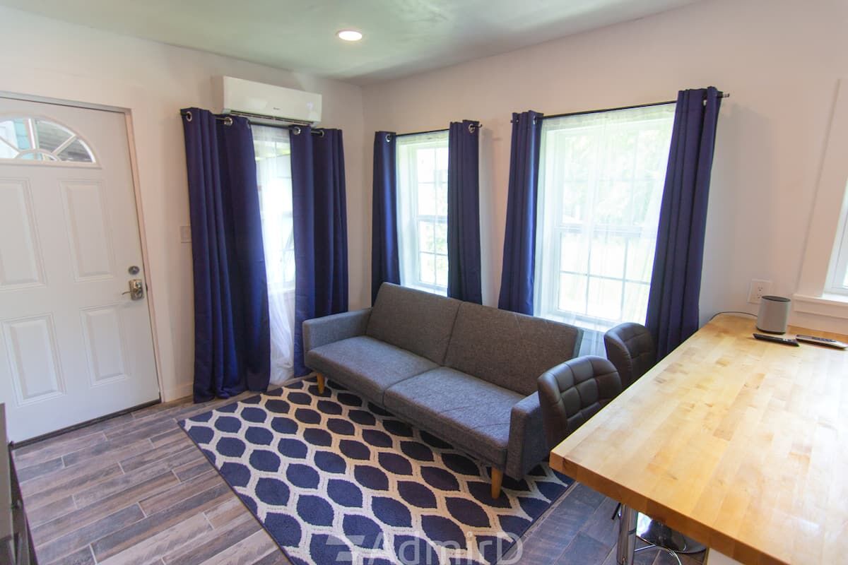Living area with a gray sofa and navy curtains