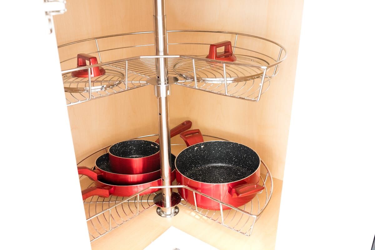 Corner cabinet with pots and pans in the studio kitchenette