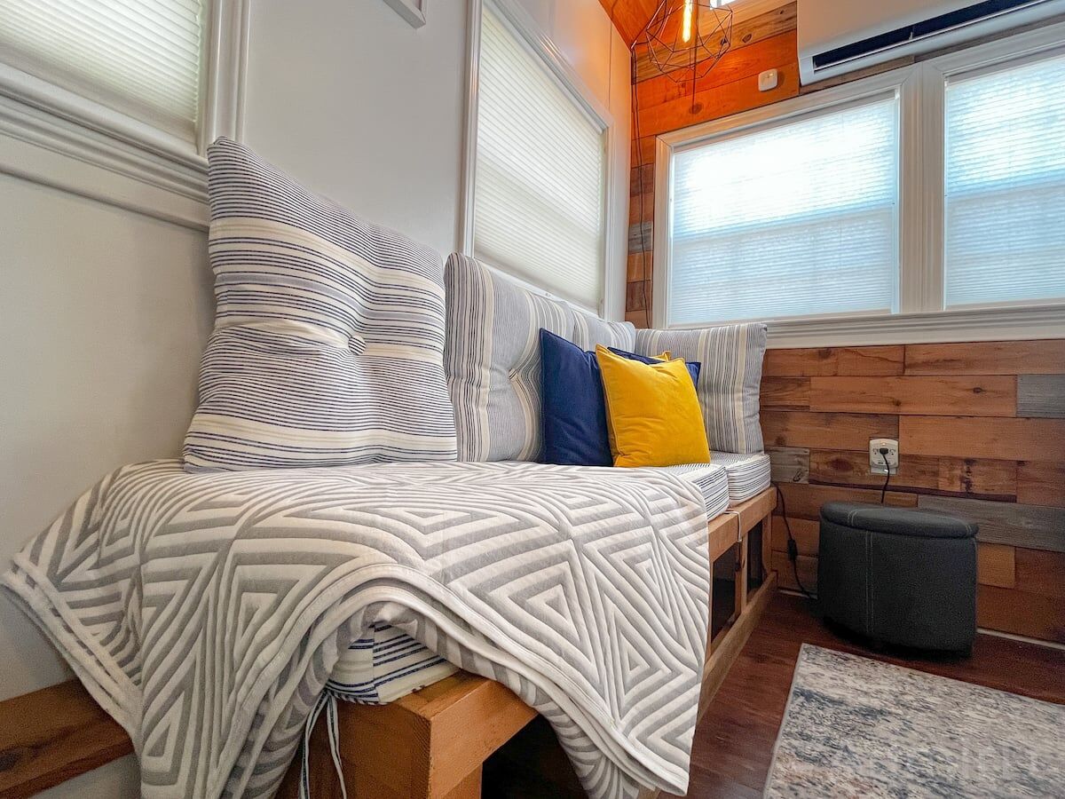 Bench seating with throw pillows in the Houston Tiny House
