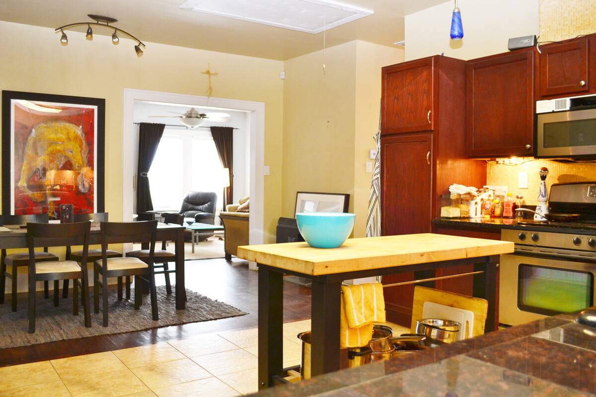 Shared kitchen with a butcher-block island and wood cabinets