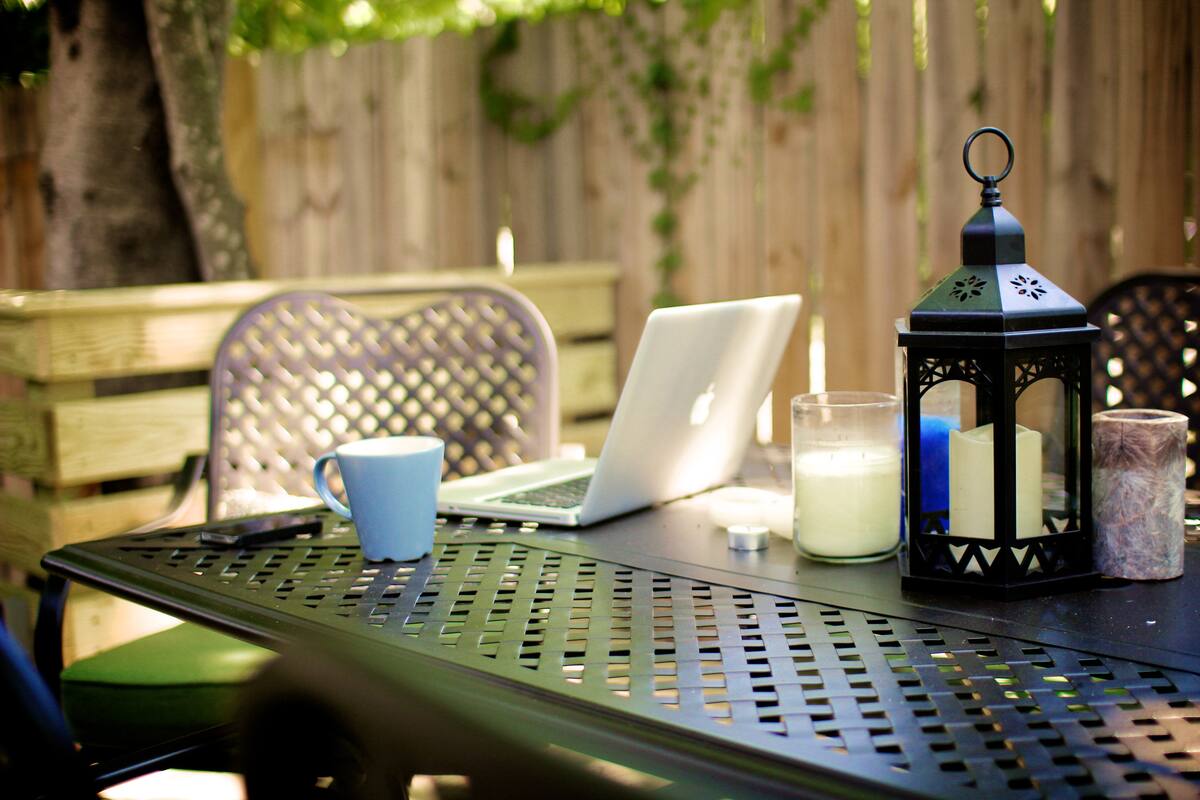Back patio table with a laptop and lantern