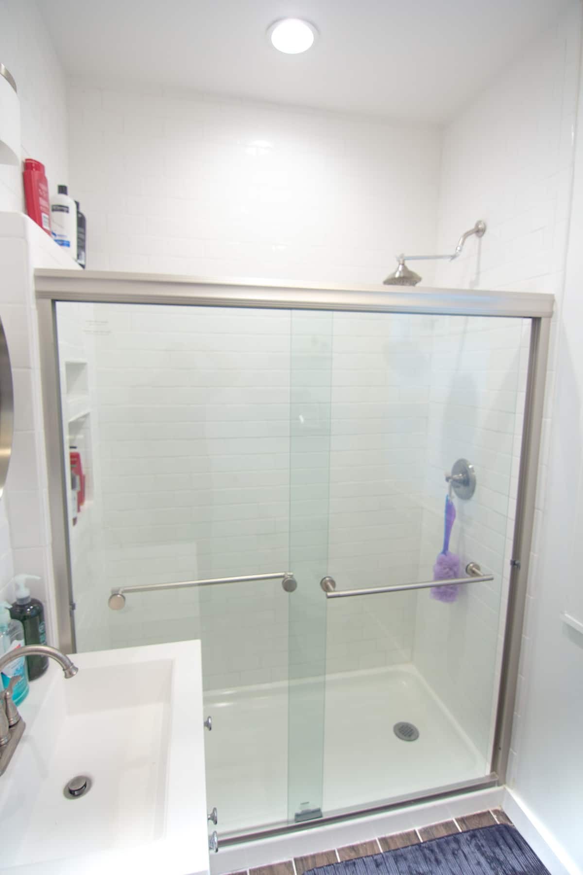 Shared bathroom with a glass shower door and vanity