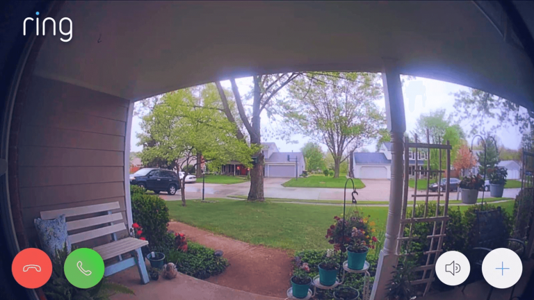 Ring video doorbell on a brick wall next to a front door